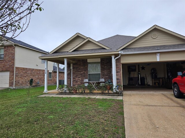 view of front facade with a front yard, a porch, and a garage