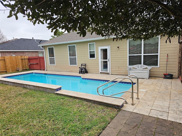 view of pool featuring a lawn and a patio area