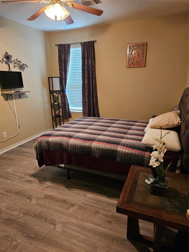 bedroom featuring hardwood / wood-style flooring and ceiling fan