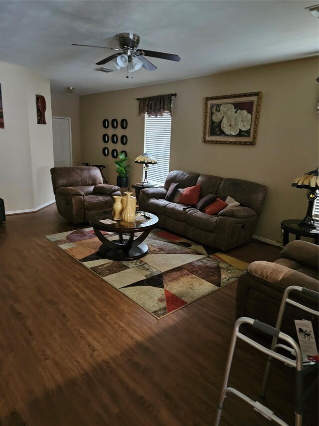 living room featuring dark hardwood / wood-style floors and ceiling fan