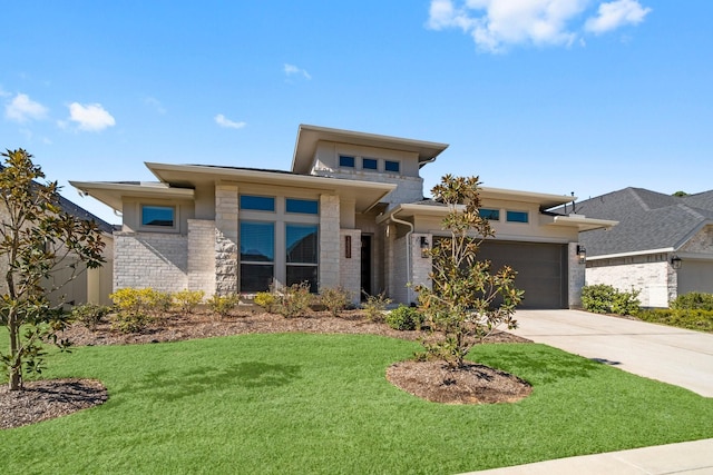 prairie-style house with a front yard and a garage