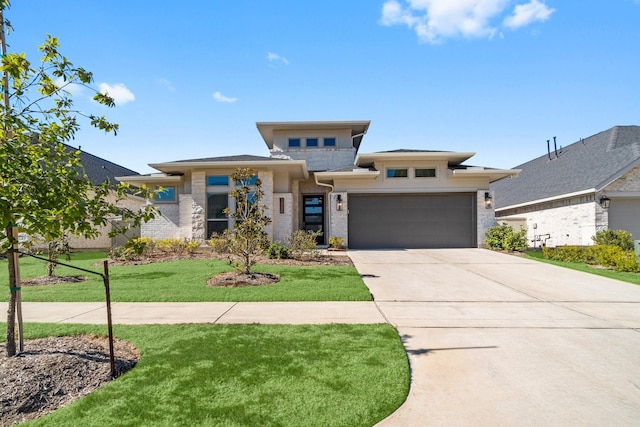 prairie-style house featuring a front yard and a garage