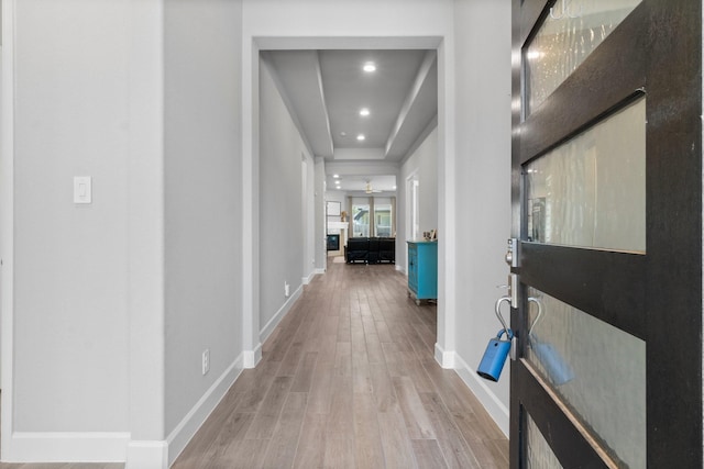 hallway with light hardwood / wood-style floors