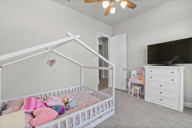 bedroom featuring light carpet and ceiling fan