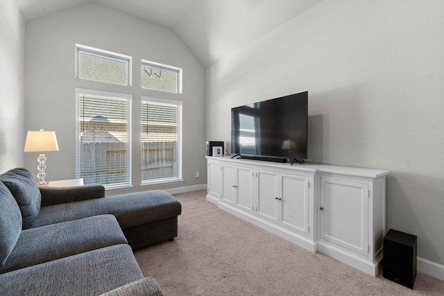 carpeted living room with lofted ceiling