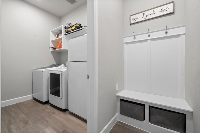 washroom featuring separate washer and dryer and wood-type flooring