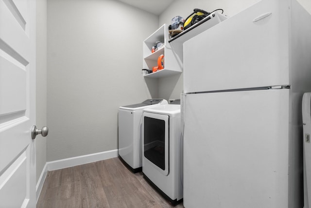 washroom featuring washer and dryer and light hardwood / wood-style flooring