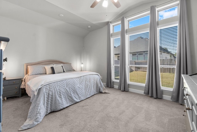 bedroom with ceiling fan, light carpet, and vaulted ceiling