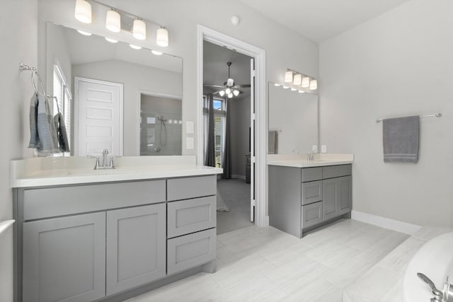 bathroom featuring ceiling fan, a shower with shower door, and vanity