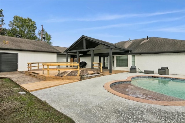 rear view of property with a patio area and a pool side deck