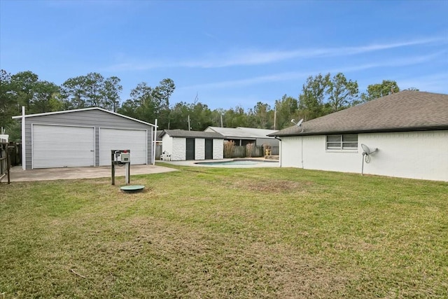 view of yard featuring an outbuilding and a garage