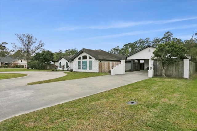 ranch-style house featuring a front yard and a carport