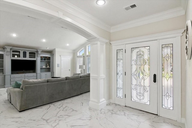 entrance foyer with vaulted ceiling, crown molding, and decorative columns