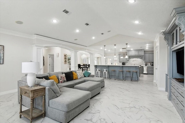 living room featuring decorative columns, crown molding, and lofted ceiling