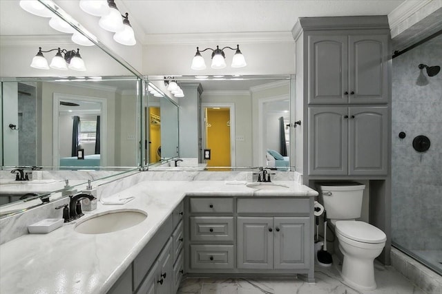 bathroom with vanity, toilet, a shower with shower door, and crown molding