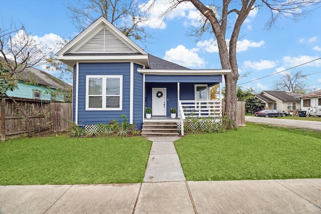 bungalow-style home with a porch and a front lawn