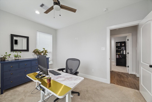 carpeted office featuring ceiling fan