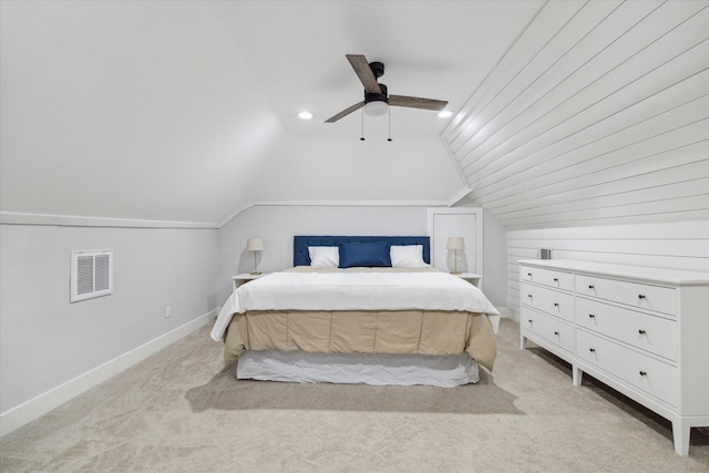 carpeted bedroom with ceiling fan and vaulted ceiling