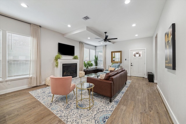 living room with ceiling fan and light hardwood / wood-style flooring