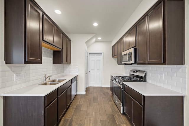 kitchen with dark brown cabinetry, sink, and appliances with stainless steel finishes