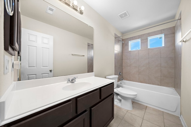 full bathroom with toilet, vanity, tile patterned floors, and tiled shower / bath