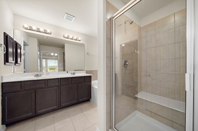 bathroom featuring vanity, separate shower and tub, and tile patterned floors