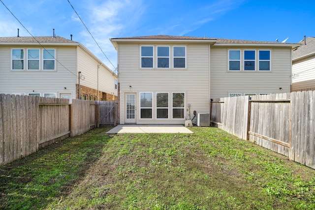 back of property with a lawn, cooling unit, and a patio