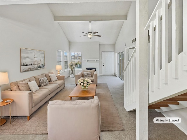 carpeted living room featuring beamed ceiling, high vaulted ceiling, and ceiling fan