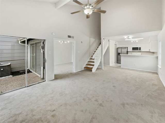 unfurnished living room featuring ceiling fan, beam ceiling, light colored carpet, and high vaulted ceiling