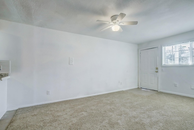 unfurnished room with ceiling fan and light carpet