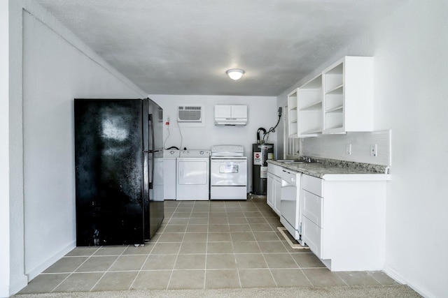 kitchen featuring white cabinetry, electric water heater, independent washer and dryer, an AC wall unit, and white appliances