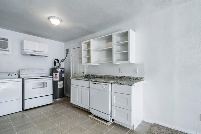 kitchen featuring sink, washing machine and dryer, electric water heater, white appliances, and white cabinets