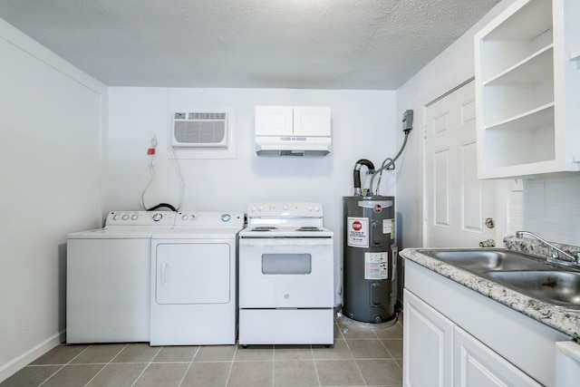 washroom with a wall mounted air conditioner, electric water heater, sink, separate washer and dryer, and a textured ceiling