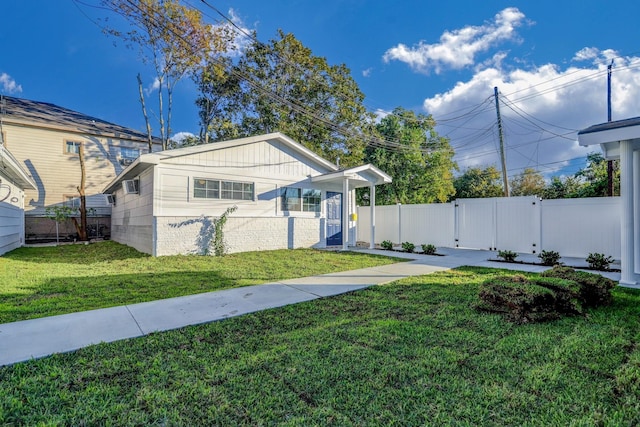 bungalow-style home with a front yard