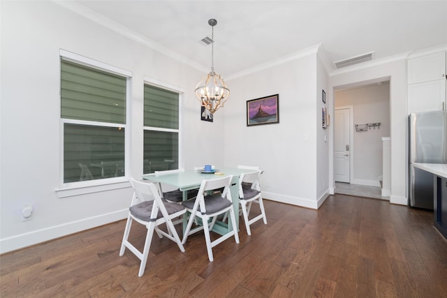 dining room featuring ornamental molding, dark wood-type flooring, and a chandelier