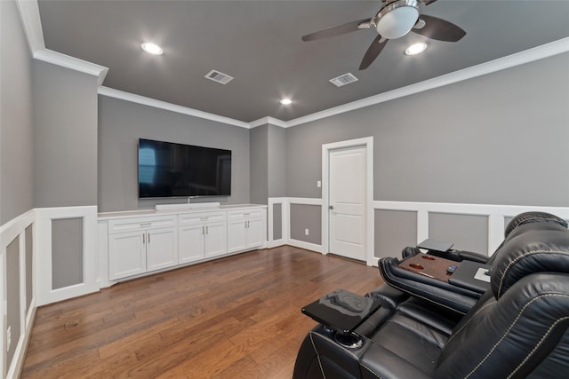 living room with ceiling fan, ornamental molding, and dark wood-type flooring