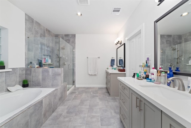 bathroom featuring tile patterned flooring, shower with separate bathtub, and vanity