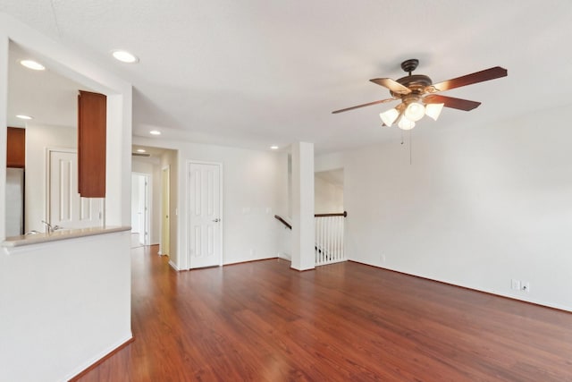 unfurnished living room featuring ceiling fan, dark wood-type flooring, and recessed lighting