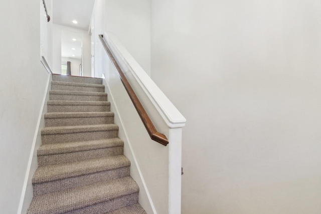 stairs featuring recessed lighting