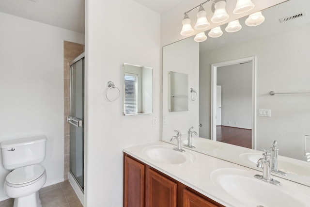 bathroom featuring a shower stall, visible vents, and a sink