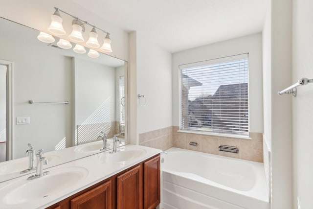 full bathroom with double vanity, a sink, and a bath