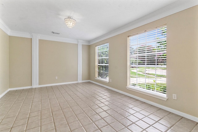 tiled empty room with crown molding and an inviting chandelier