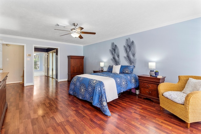 bedroom featuring dark hardwood / wood-style flooring, ceiling fan, and ornamental molding