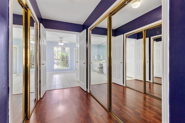 hallway with hardwood / wood-style flooring