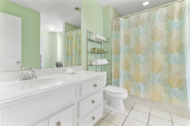 bathroom featuring tile patterned flooring, vanity, and toilet