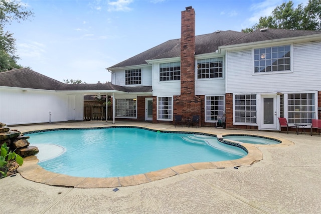 view of swimming pool with a patio area and an in ground hot tub