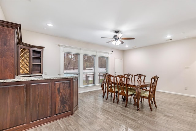 dining room with ceiling fan and light hardwood / wood-style flooring