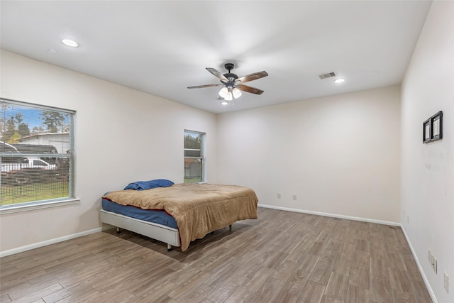 bedroom featuring ceiling fan and light hardwood / wood-style flooring