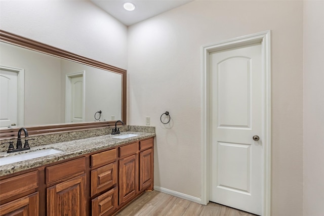 bathroom featuring hardwood / wood-style flooring and vanity