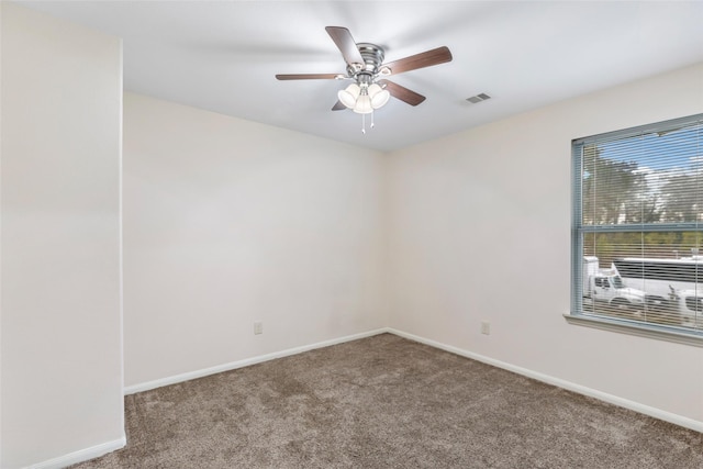 carpeted spare room featuring ceiling fan